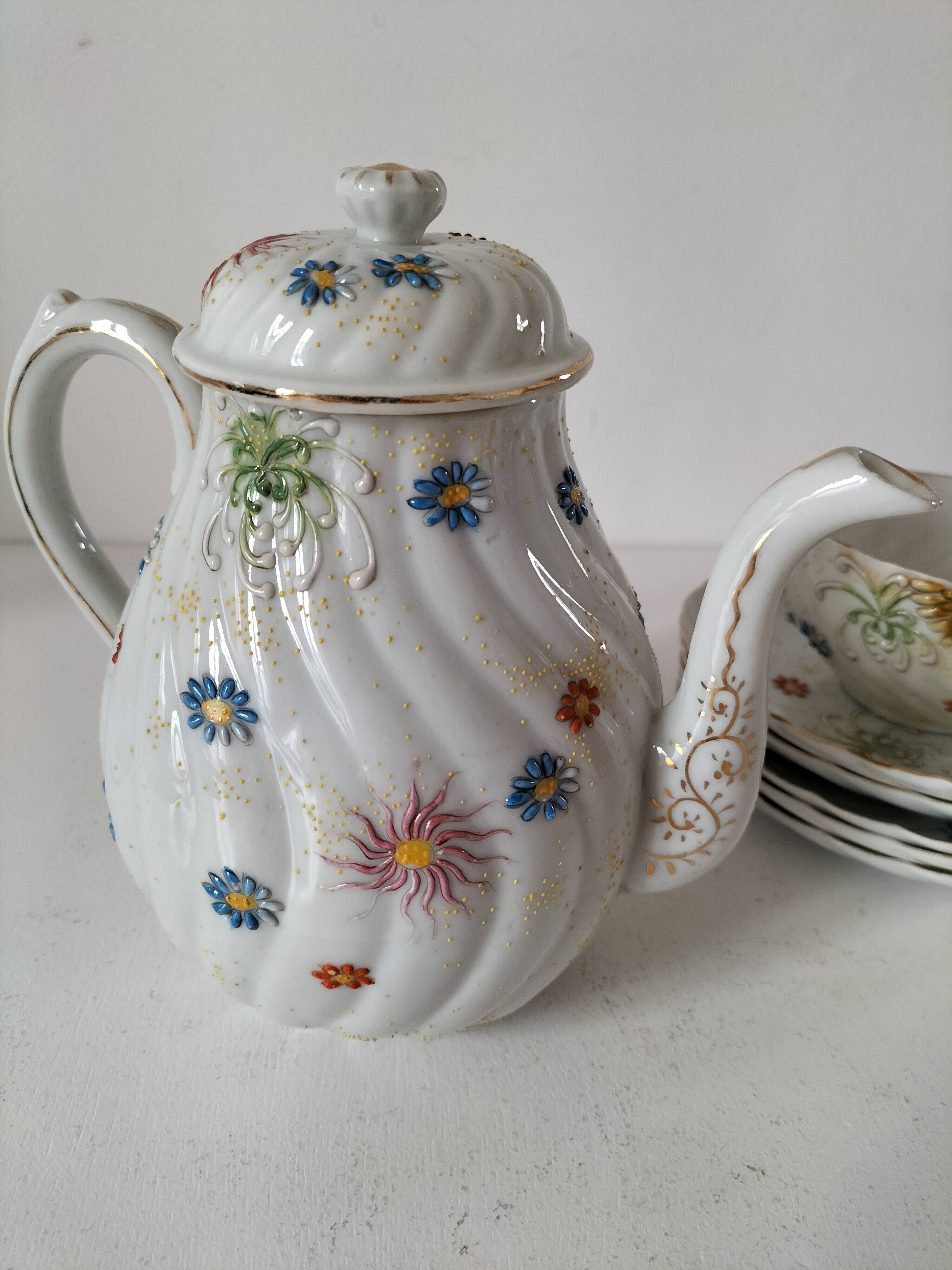 coffee pot, cup and saucers