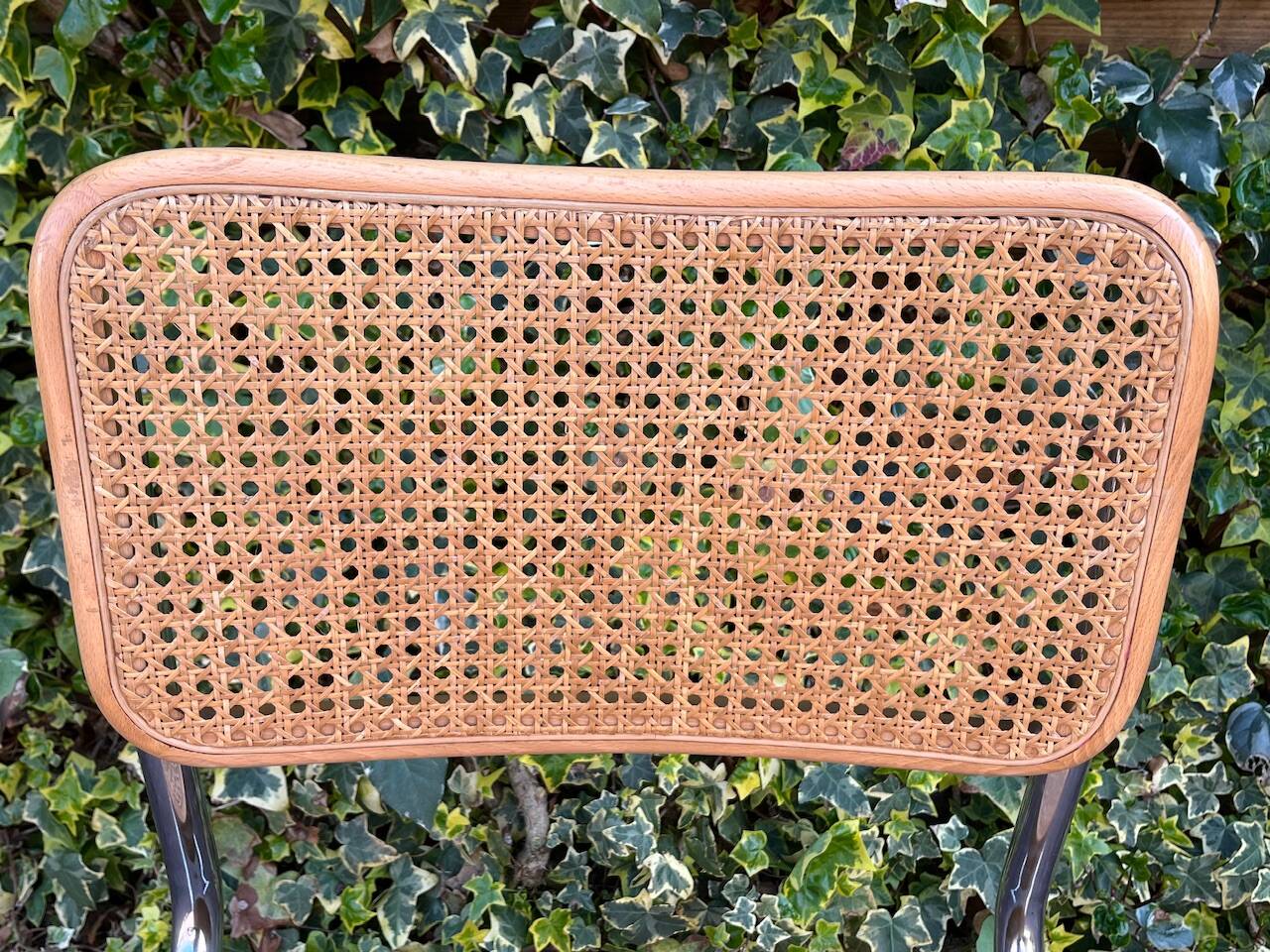 Wooden chair with caning in the style of Marcel Breuer.