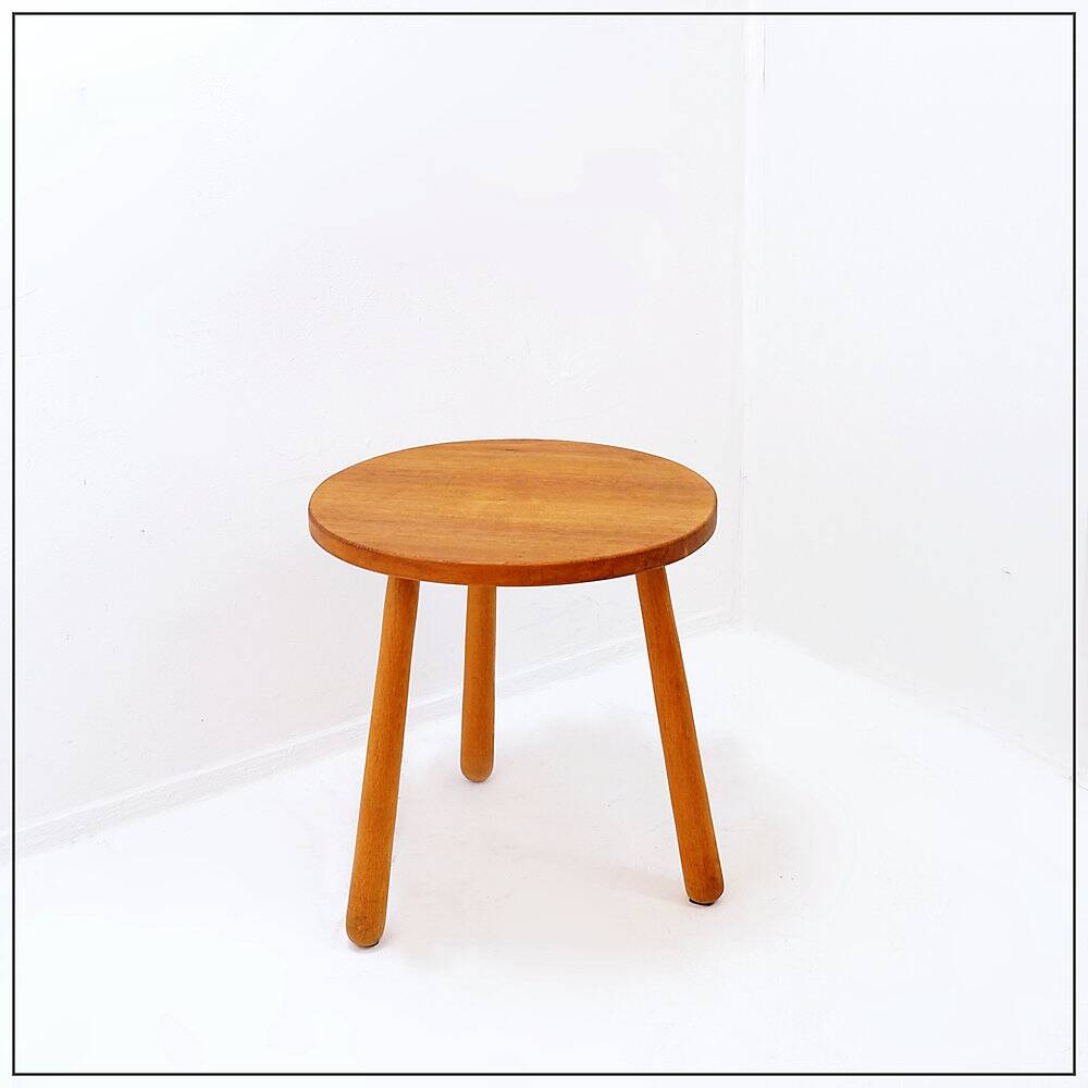 Vintage solid wood side table with rounded legs.
