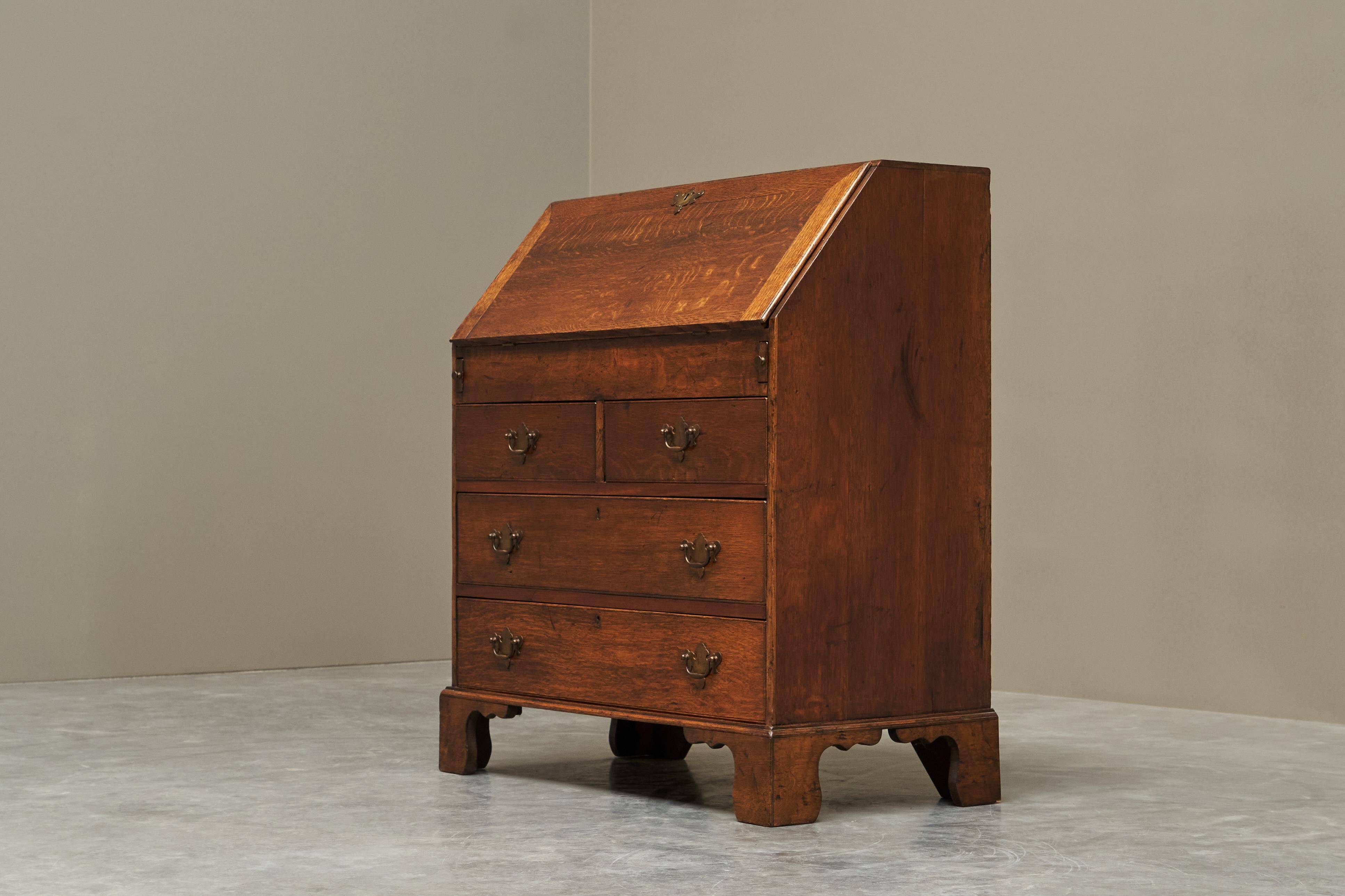 Antique English oak secretary with drop-down front.