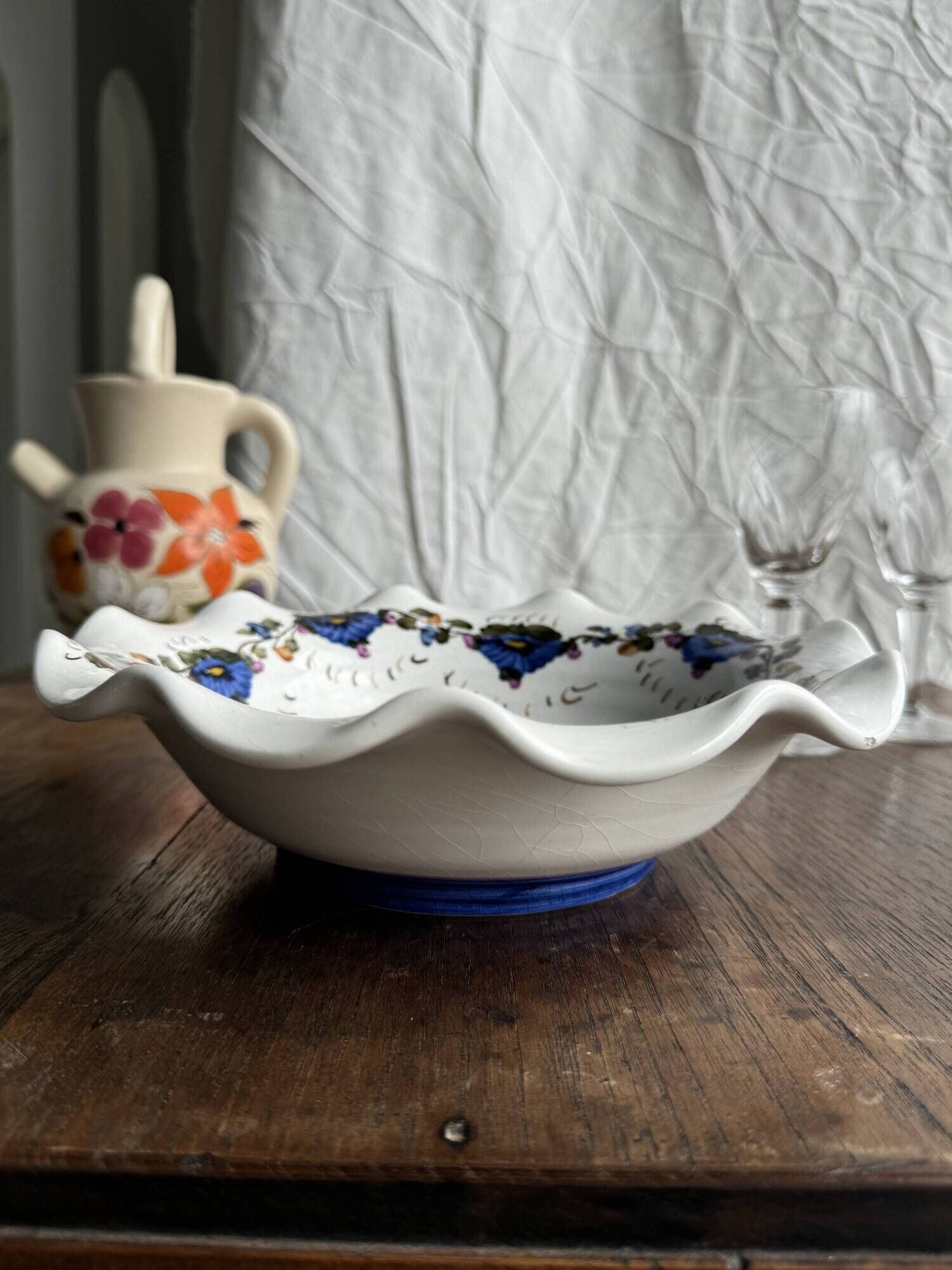 Small hand-painted earthenware salad bowl with garland of blue flowers, mark below