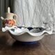 Small hand-painted earthenware salad bowl with garland of blue flowers, mark below