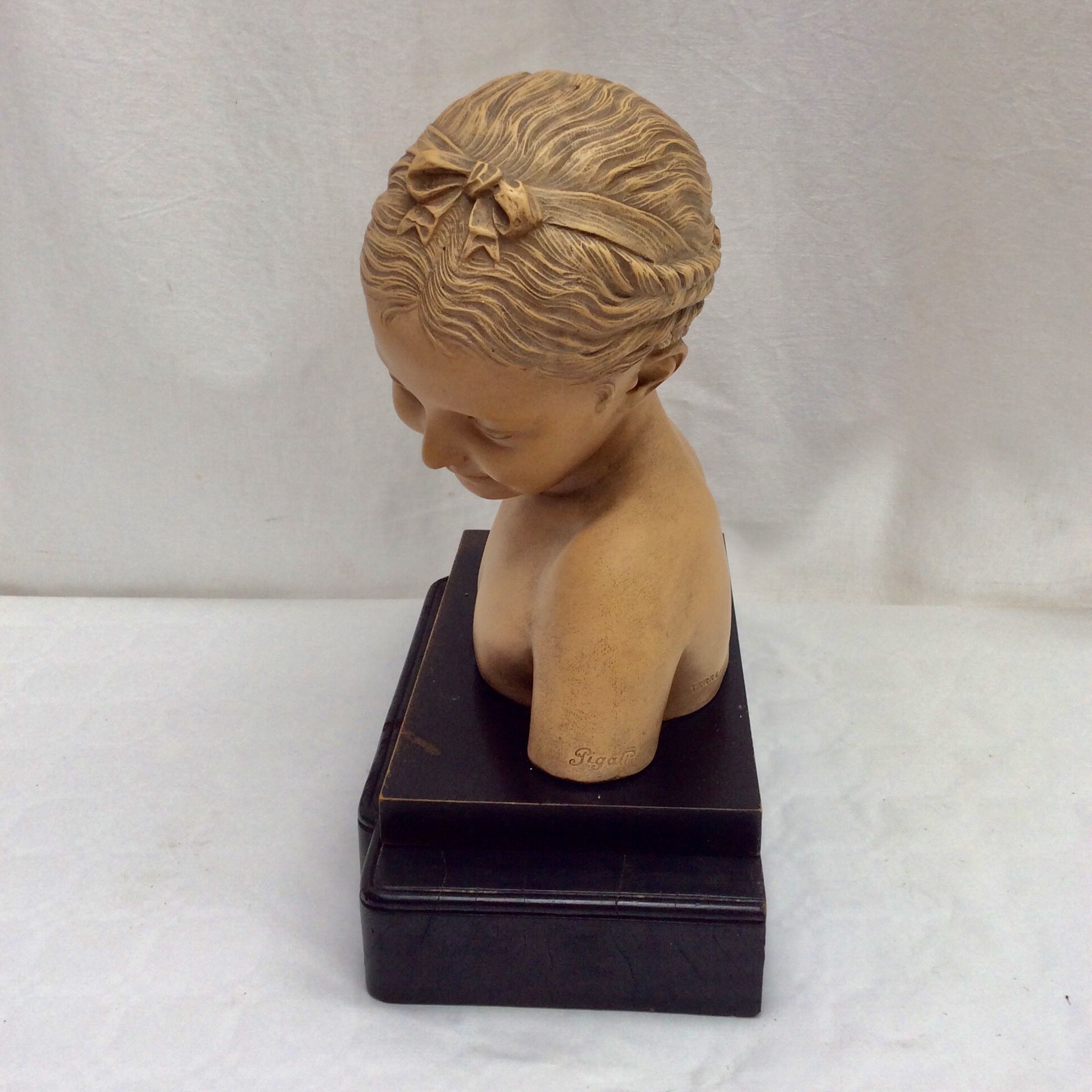 Girl's head in terracotta numbered