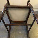 Carved wooden armchair and cannage