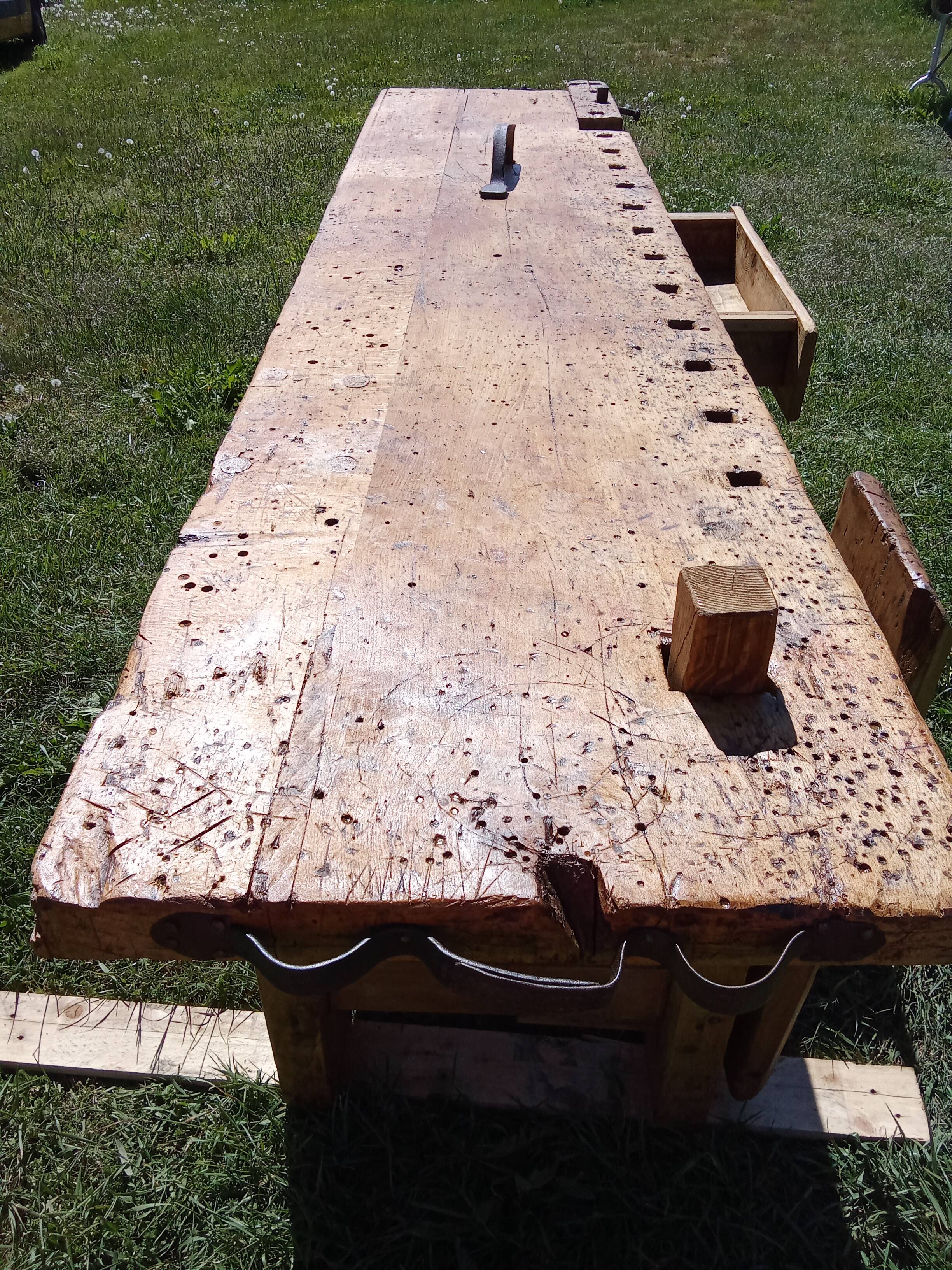 Old solid wood carpenter's bench with 2 functional vices.