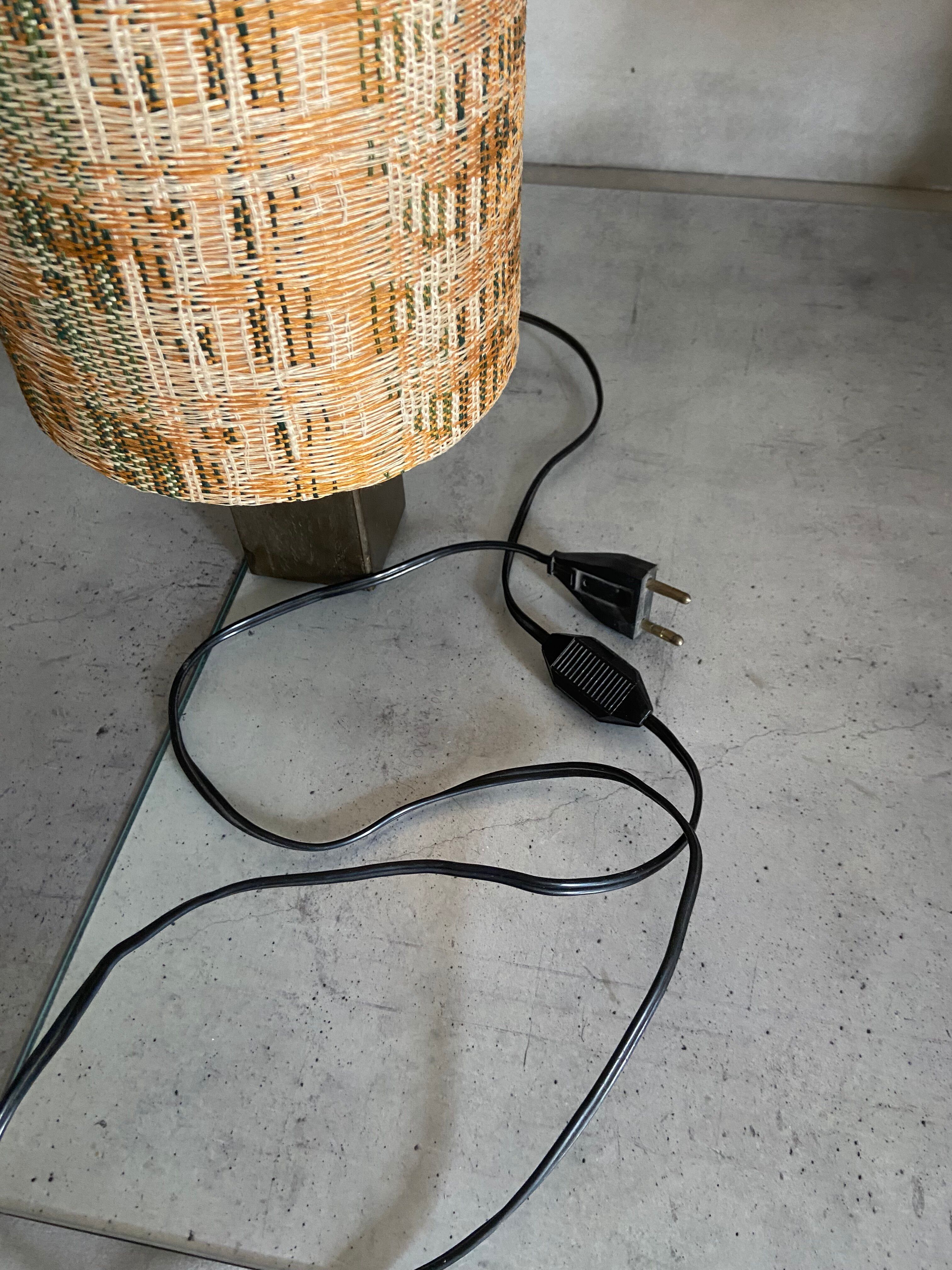 Small modernist table lamp with hand-woven shade.