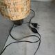 Small modernist table lamp with hand-woven shade.