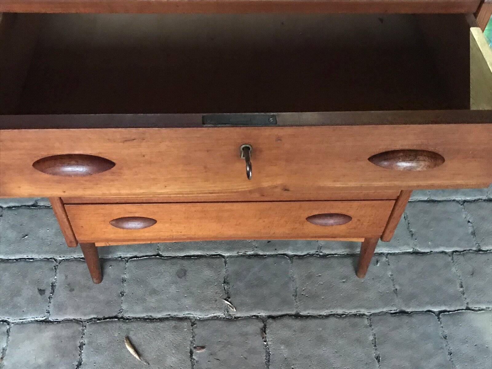 Danish commode from the 1960s in brown teak, with 4 drawers and elegant tapered legs.