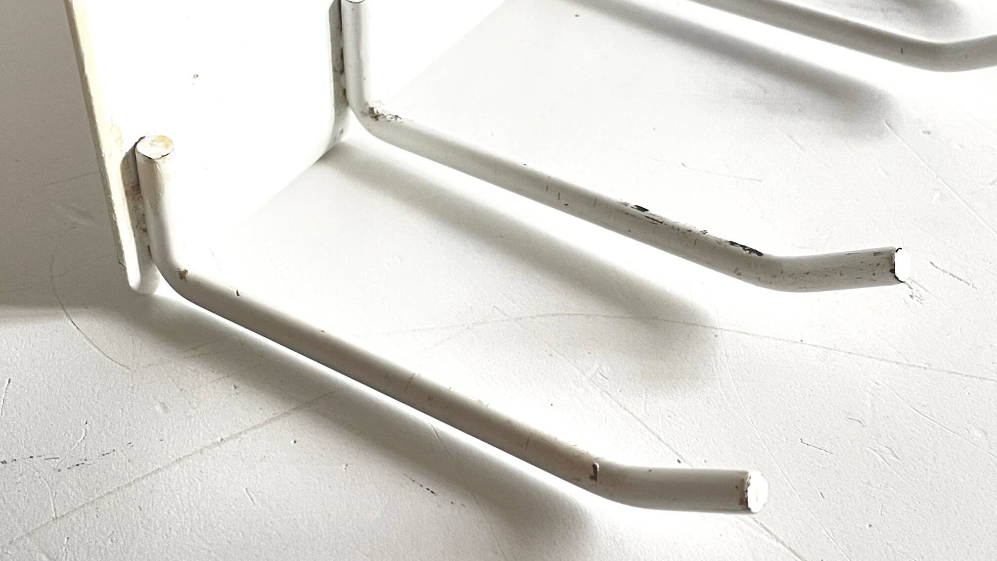 Vintage white metal wall trade coat rack
