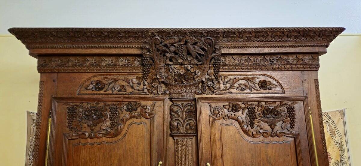 Norman Wedding Armoire in solid oak, richly carved, Louis period.