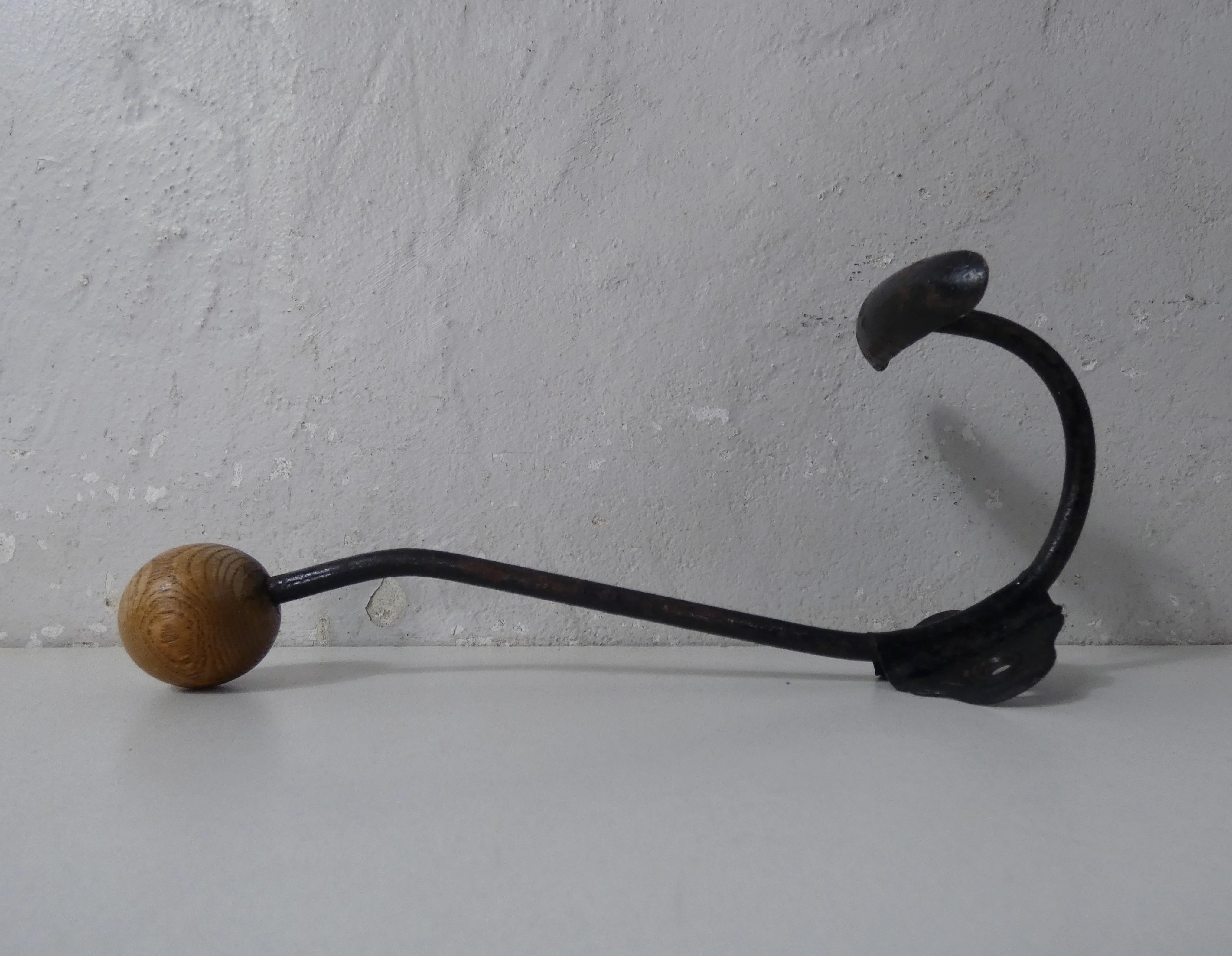Old metal hook and wooden ball