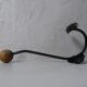Old metal hook and wooden ball
