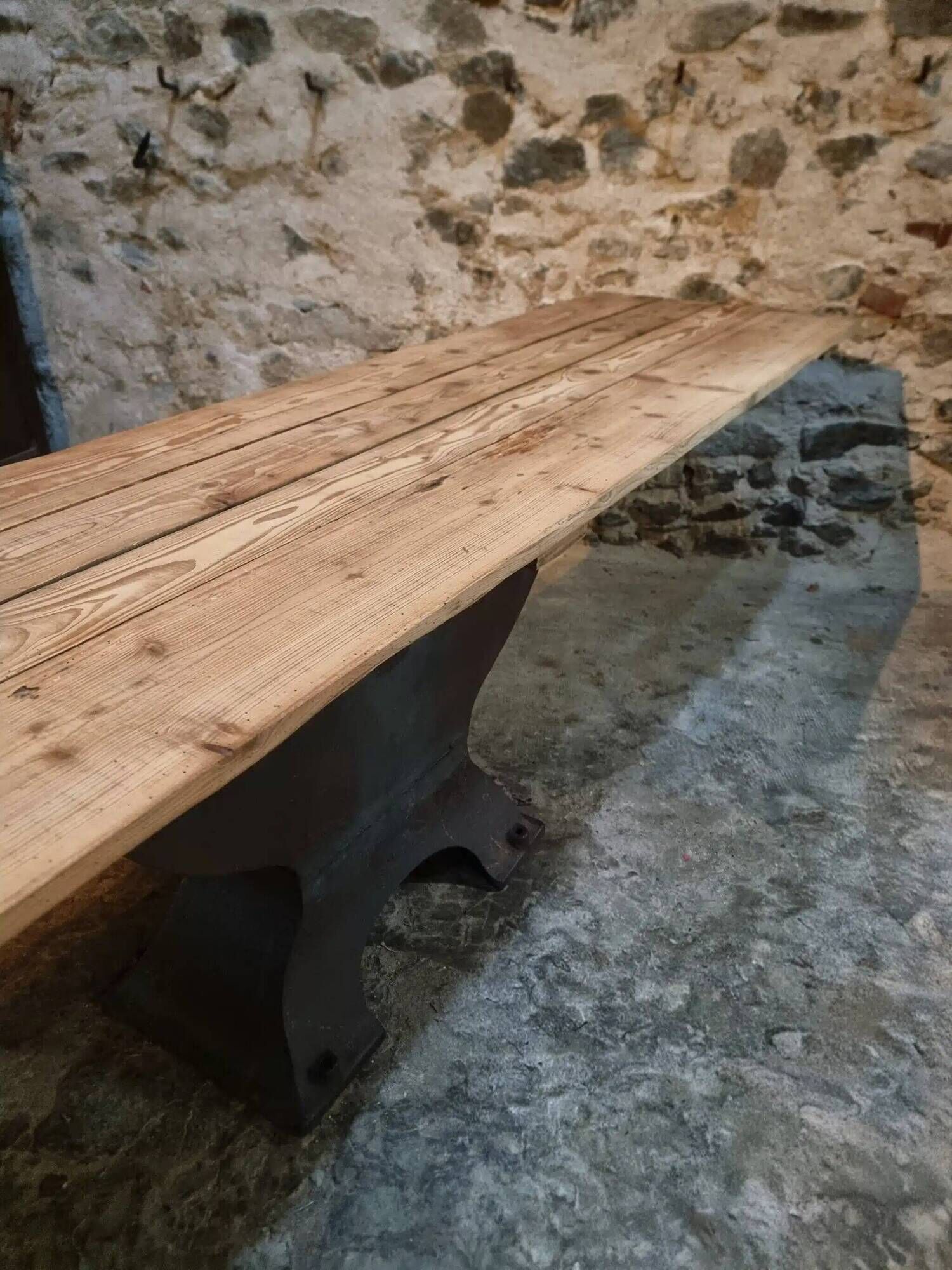 Old French industrial table with a cast iron base and a pine top.