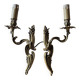 Pair of symmetrical gold wall sconces in baroque style made of bronze.