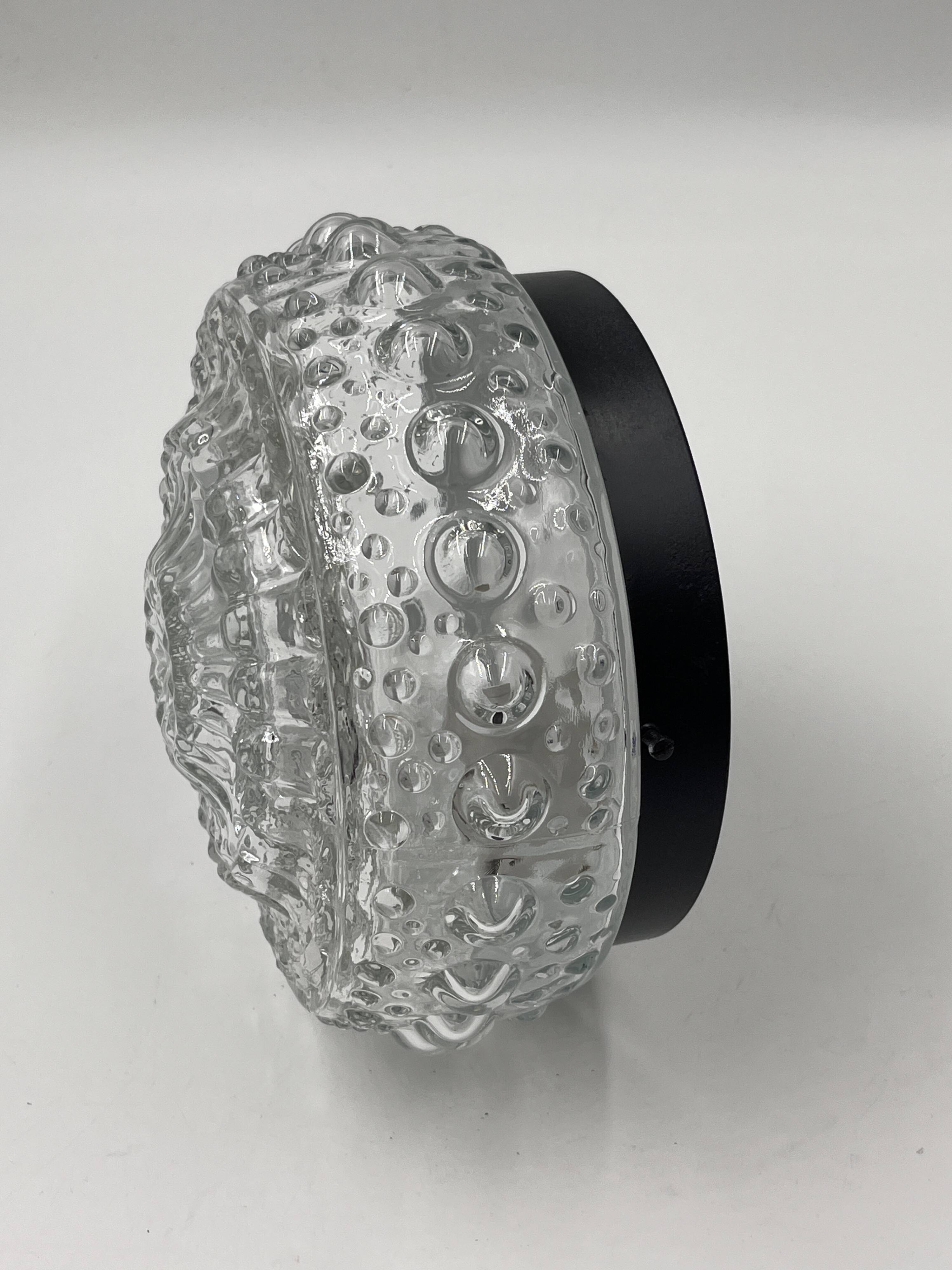 Molded glass ceiling light with spinning top relief