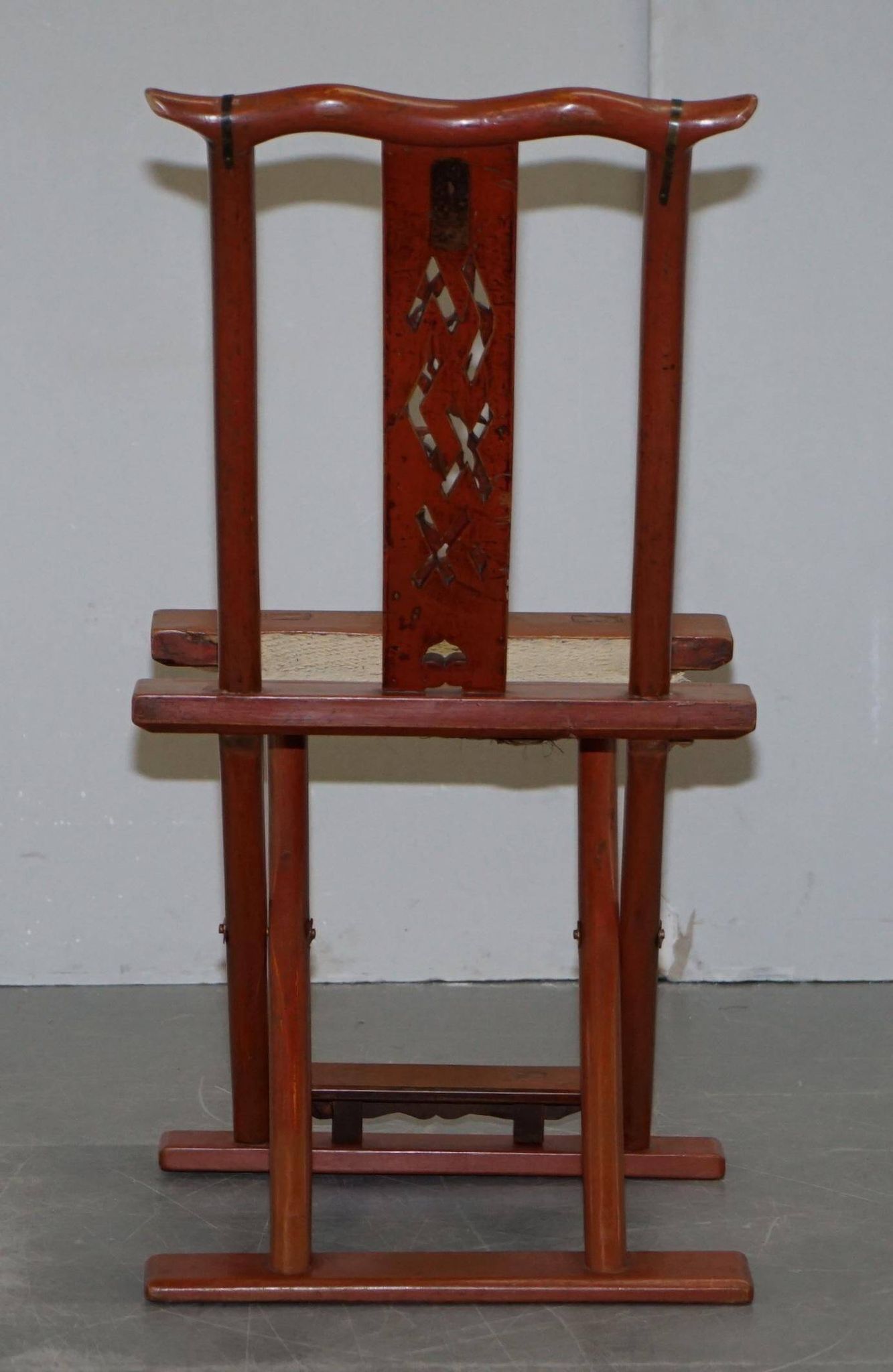 Antique Chinese folding chair with carvings, circa 1900-1920.