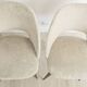Pair of vintage barrel chairs in boucle fabric with brass splayed legs.