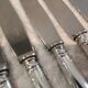 12 silver-plated metal dessert knives with rocaille ribbon decoration, 21.4 cm