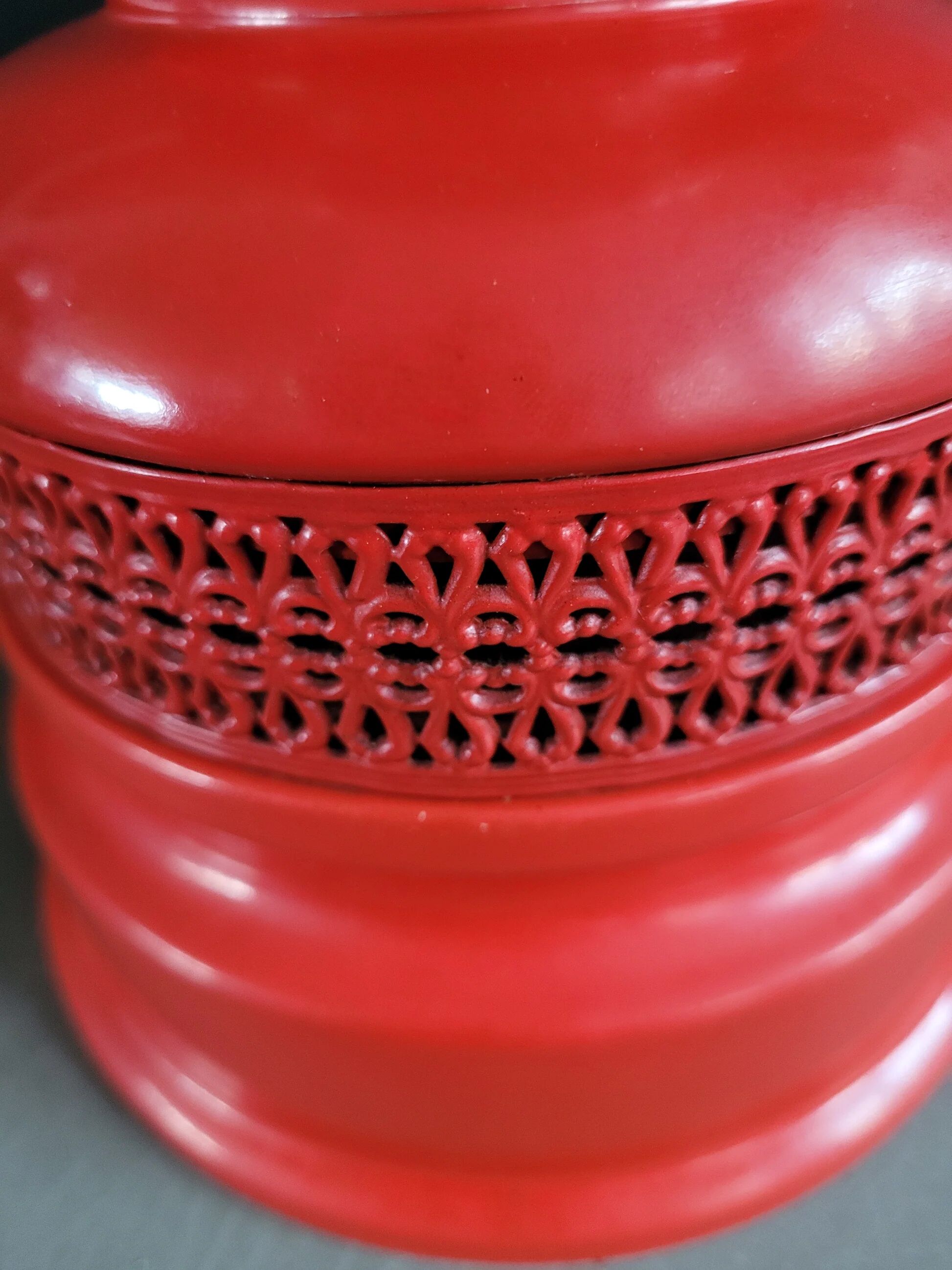 Vintage globe lamp with a metal base, perforated and lacquered in red.