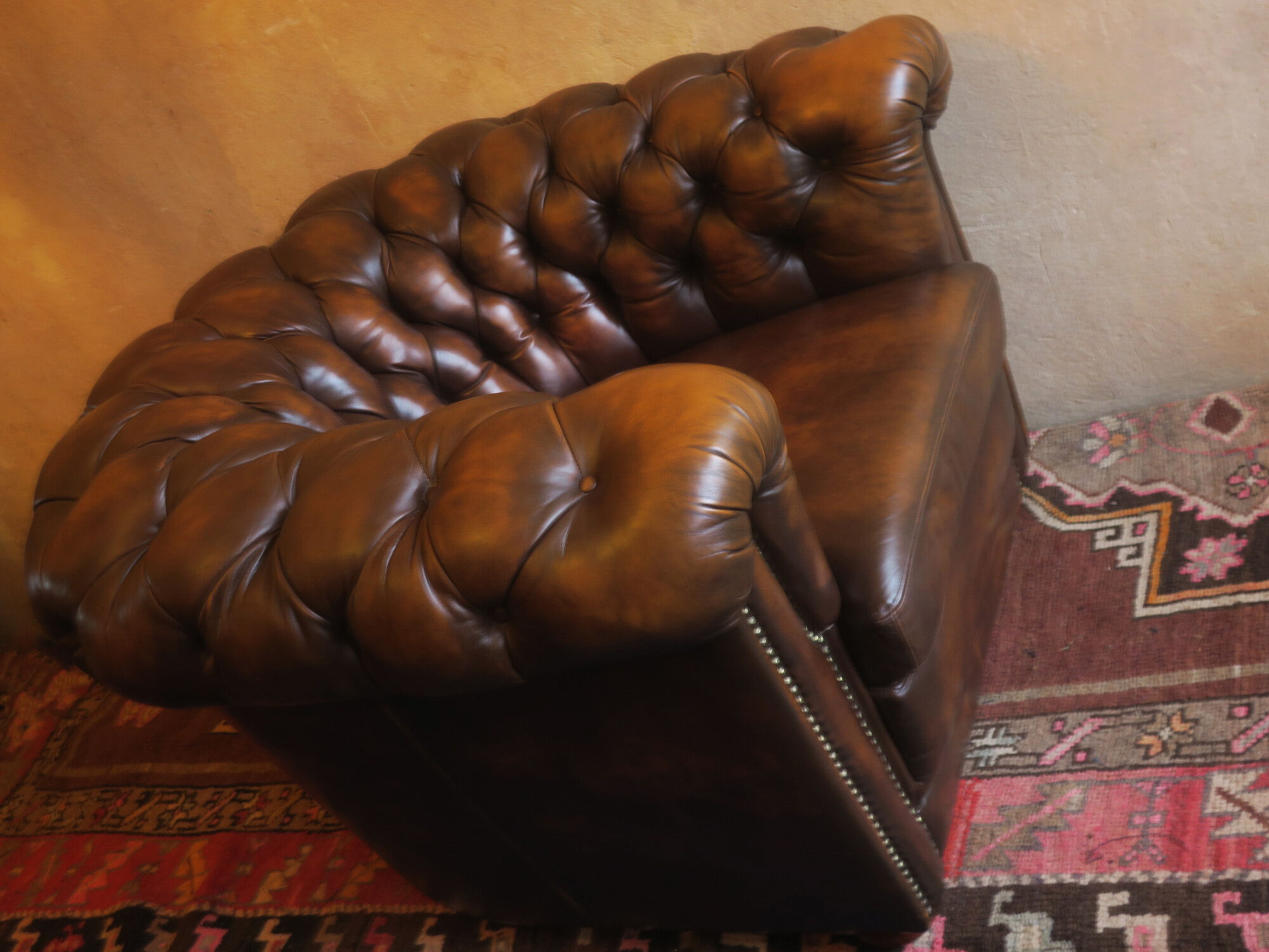 Chesterfield club armchair in patinated chestnut coloured leather