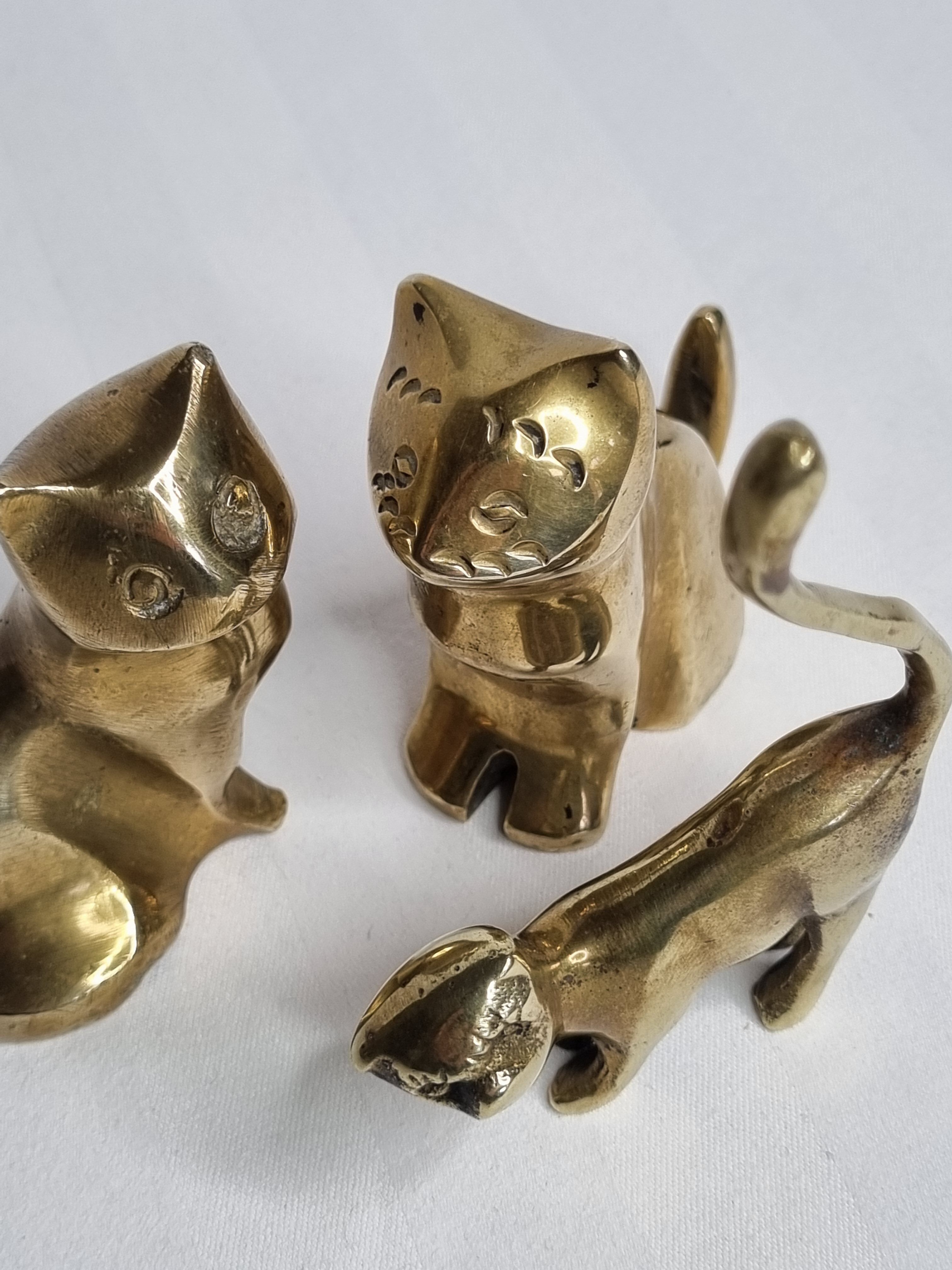 Set of three brass cats