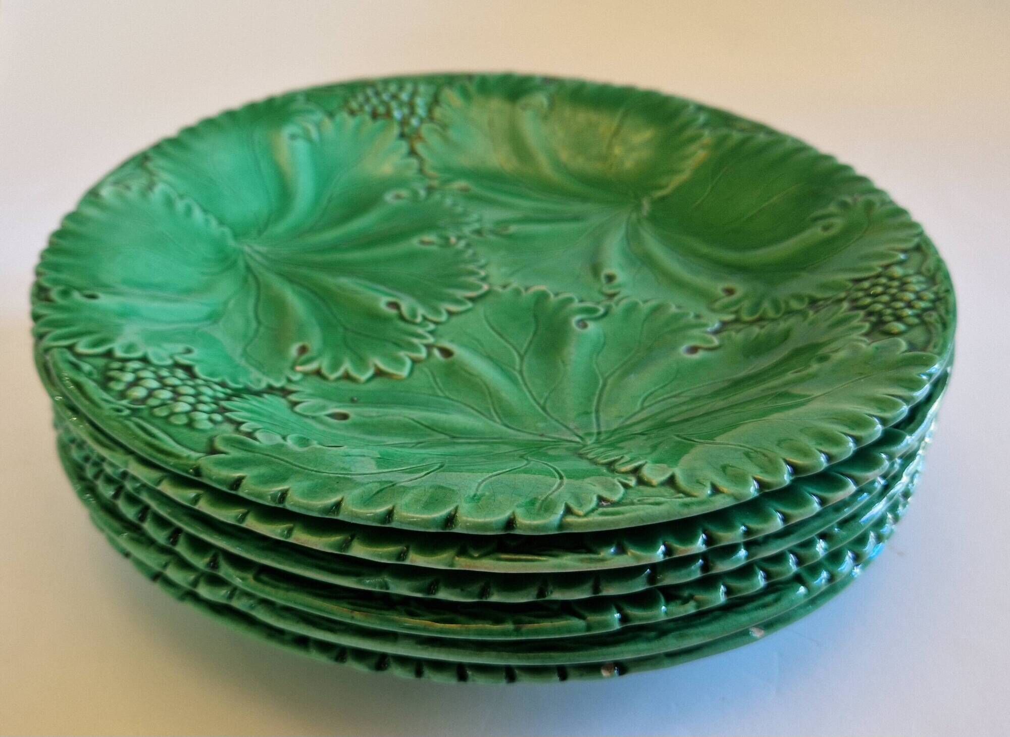 8 green barbotine plates from the early 20th century.
