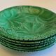 8 green barbotine plates from the early 20th century.