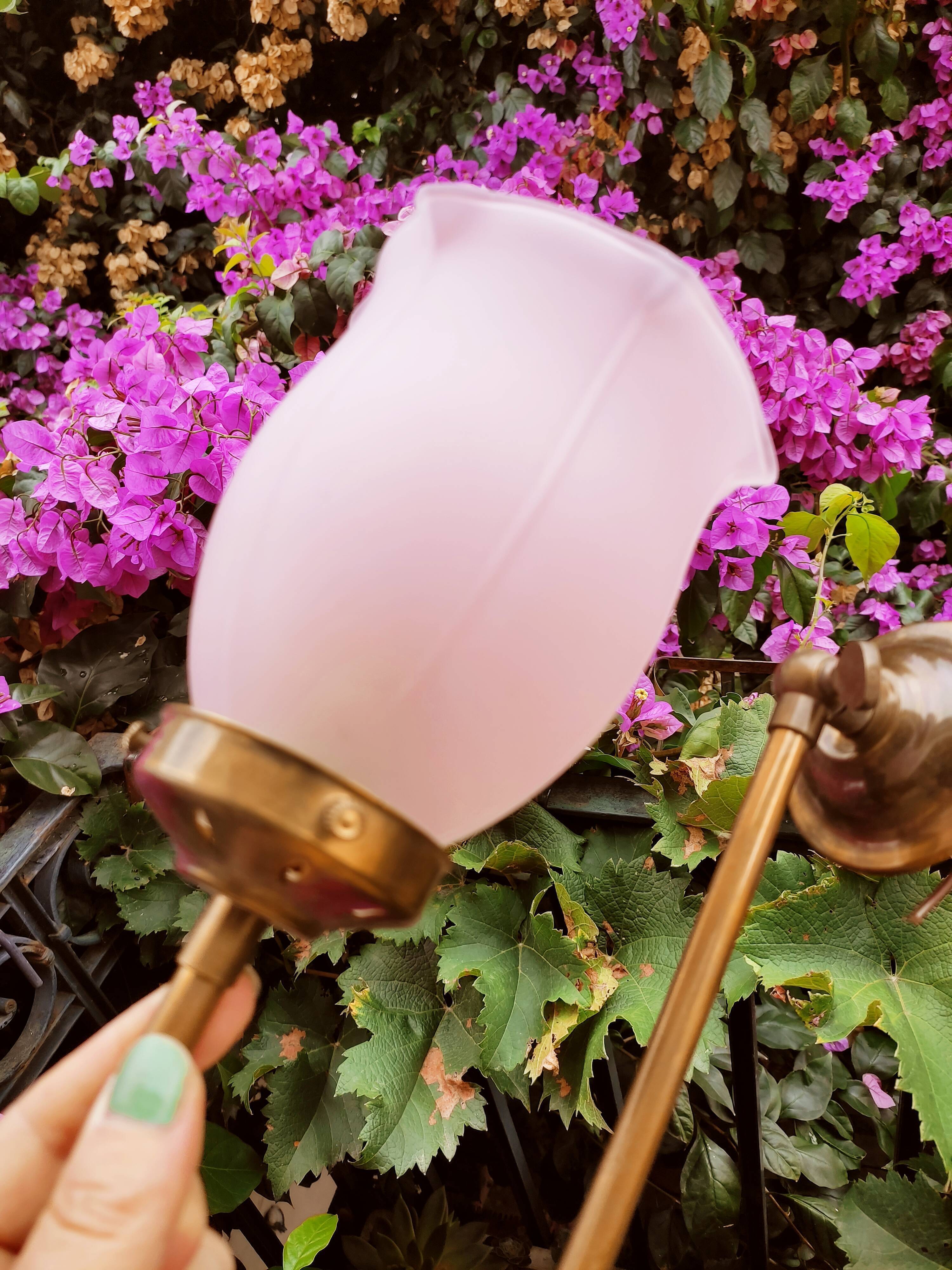 Brass wall lamp with pale pink bell
