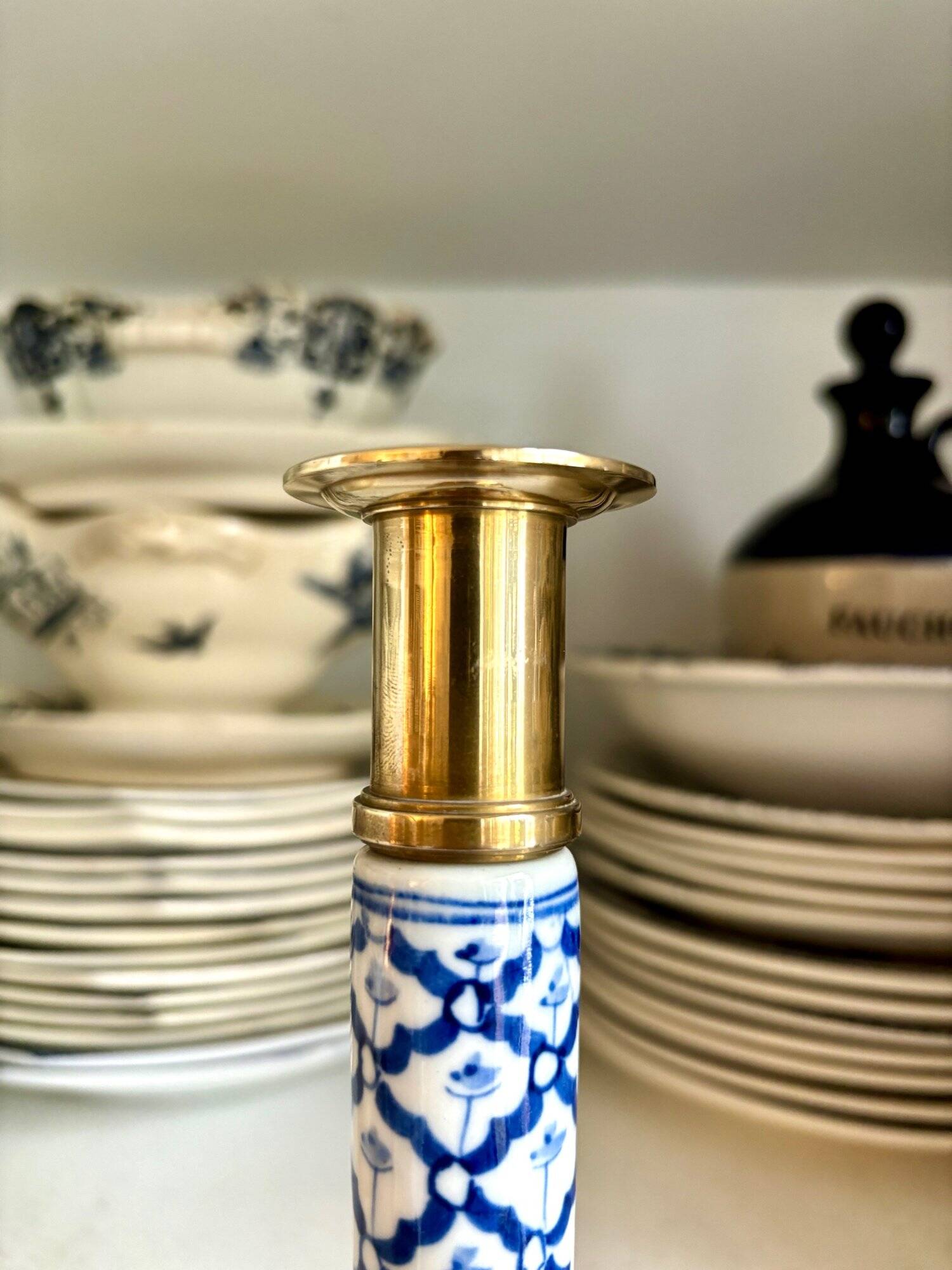 Candlestick in gilded brass and blue earthenware