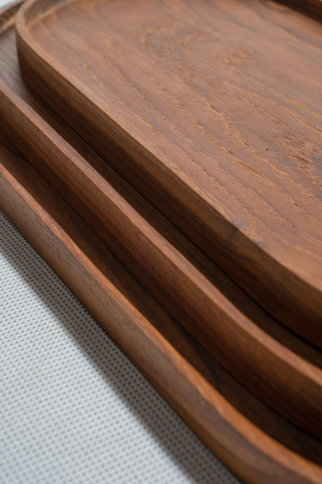 Trio of oval teak trays or cups