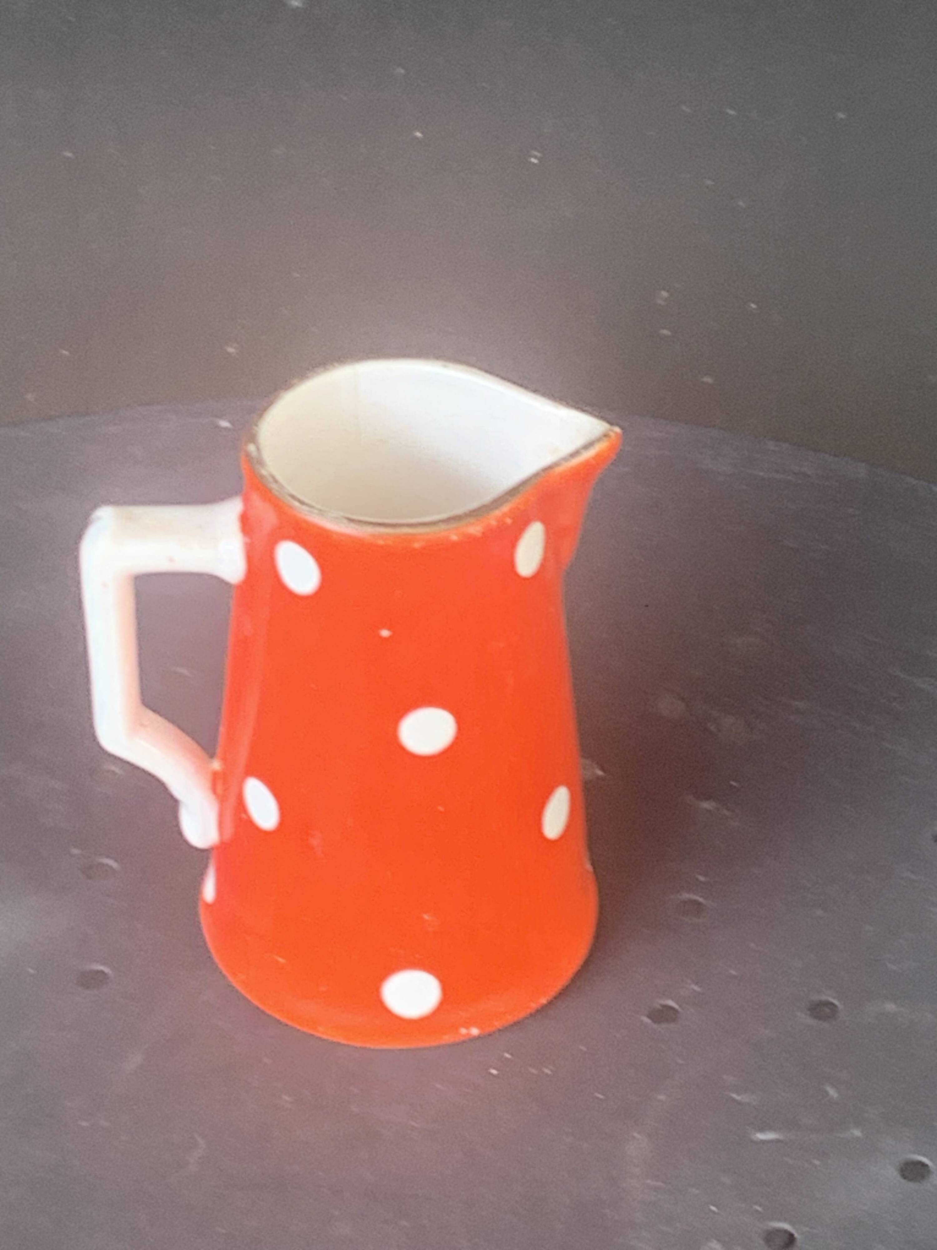 Milk jug, pitcher with white polka dots on orange earthenware, Sarreguemines and Digoin