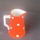 Milk jug, pitcher with white polka dots on orange earthenware, Sarreguemines and Digoin
