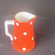 Milk jug, pitcher with white polka dots on orange earthenware, Sarreguemines and Digoin