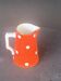 Milk jug, pitcher with white polka dots on orange earthenware, Sarreguemines and Digoin