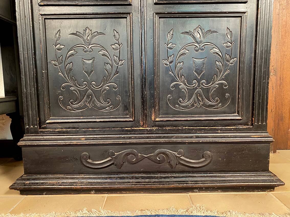 Blackened wooden display cabinet from the late 19th or early 20th century.