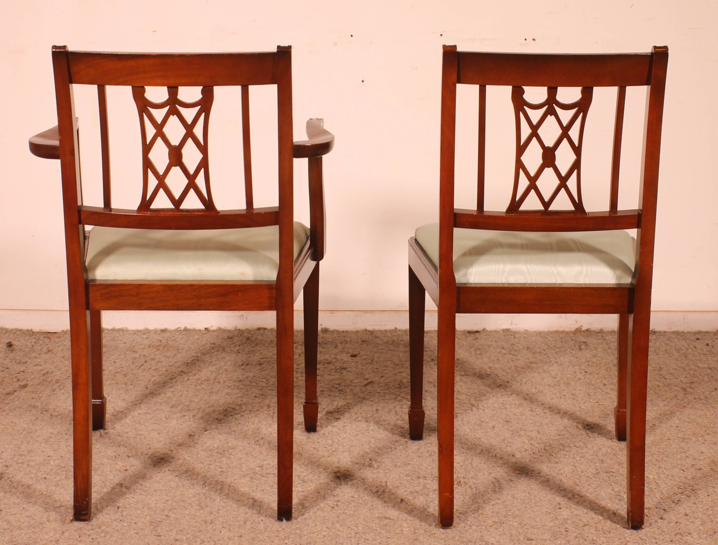 set of 10 chairs and two mahogany armchairs in Hepplewhite style