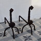 Vintage metal and cast iron fire dogs with shell motif.
