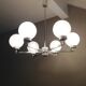 Six-light chrome metal chandelier and opaque glass globes / vintage 60s and 70s