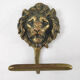 Pair of brass lion head patères