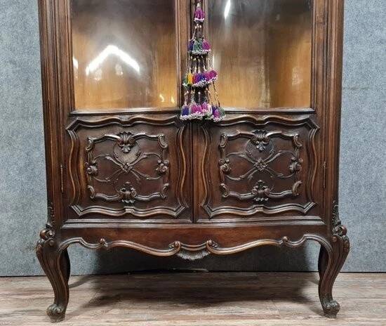 Curved library with two walnut doors, in Louis XV style.