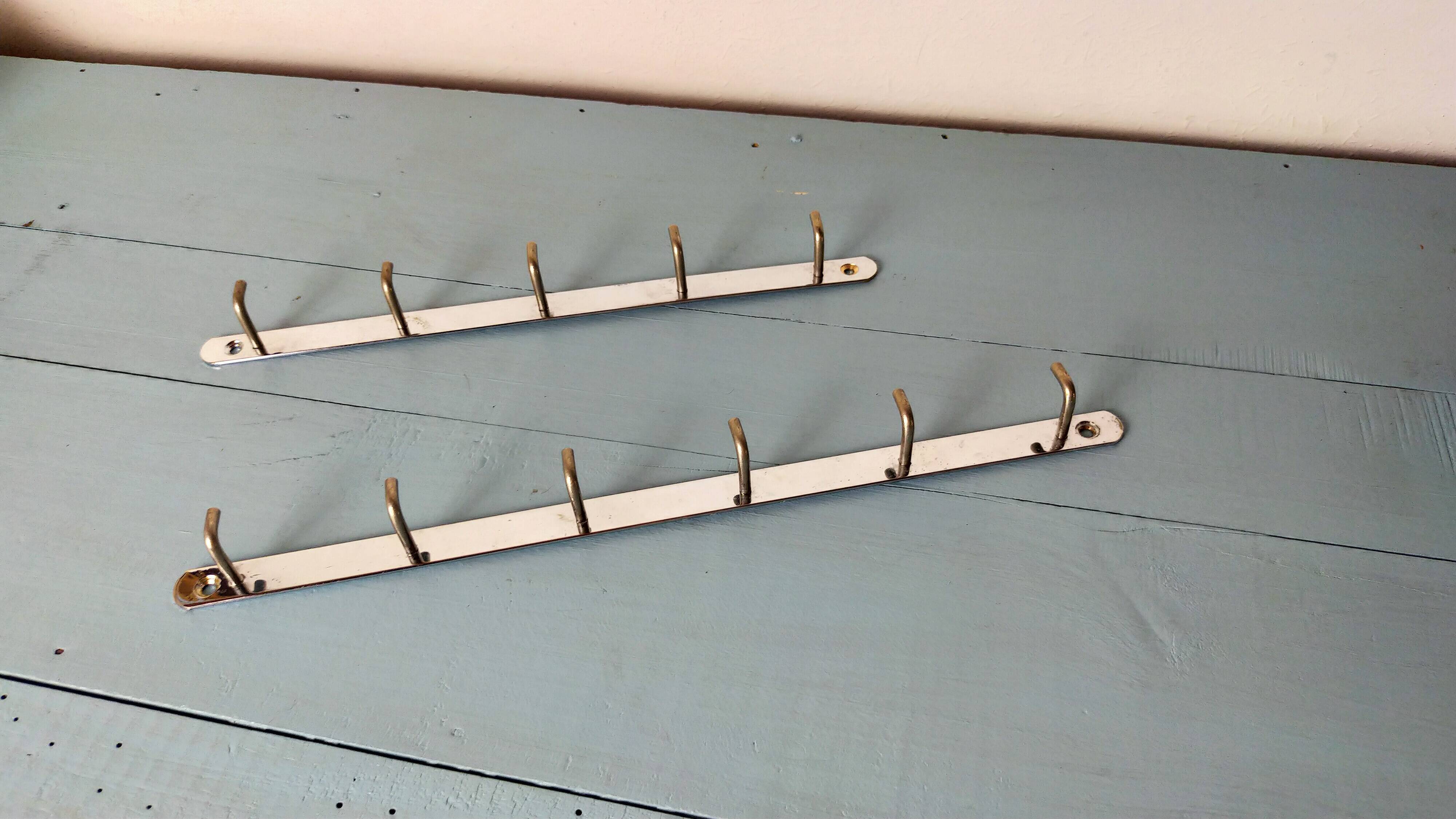 Two chrome tea towel hooks