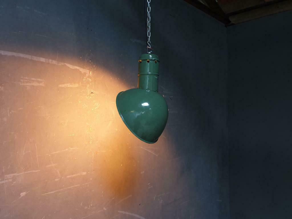 Old industrial enamel lamp in green