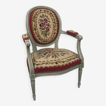 Louis XVI style armchair in grey lacquered wood, medallion backrest, upholstered with tapestry with small poin