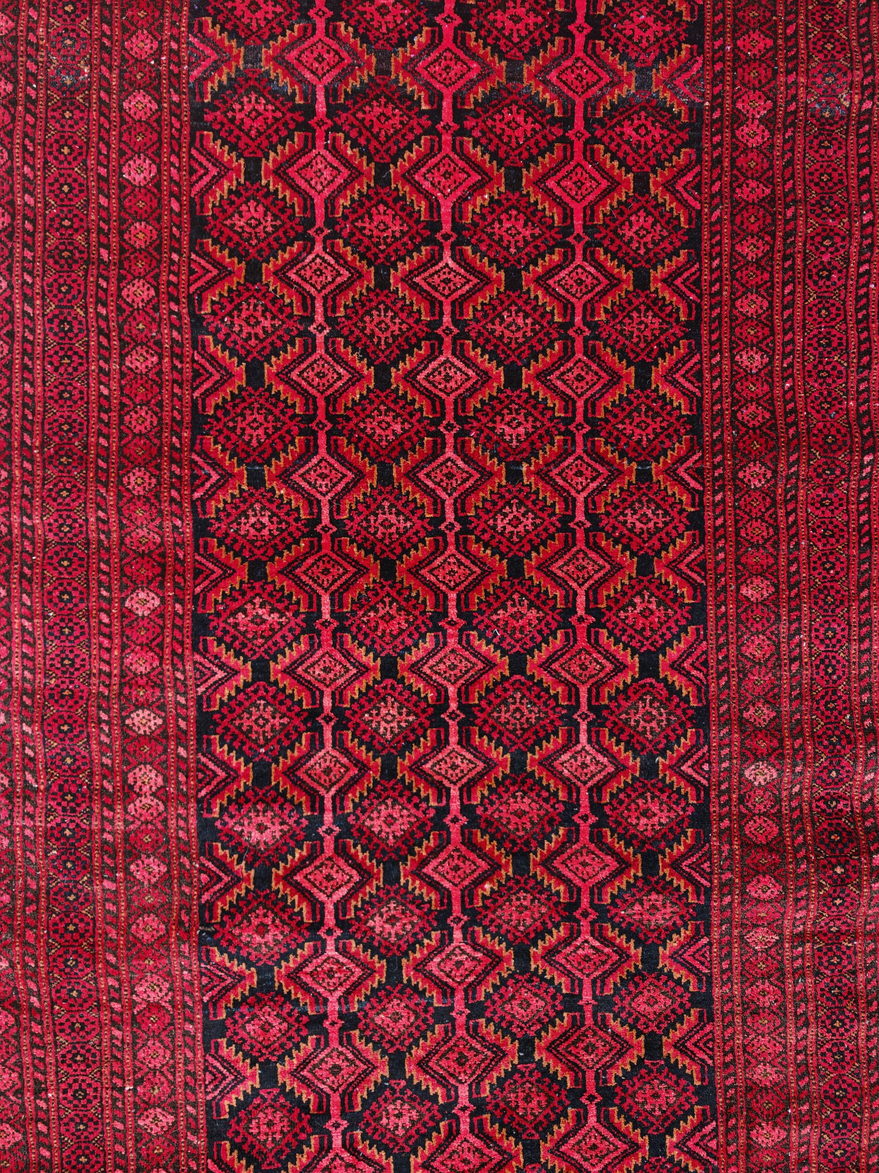 Vintage Baluch carpet handmade from natural wool, Afghanistan 1960.