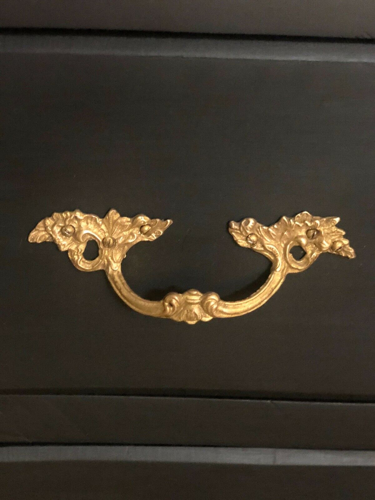 Louis XV style curved black matte commode with gilded bronze ornamentation from the 1950s.