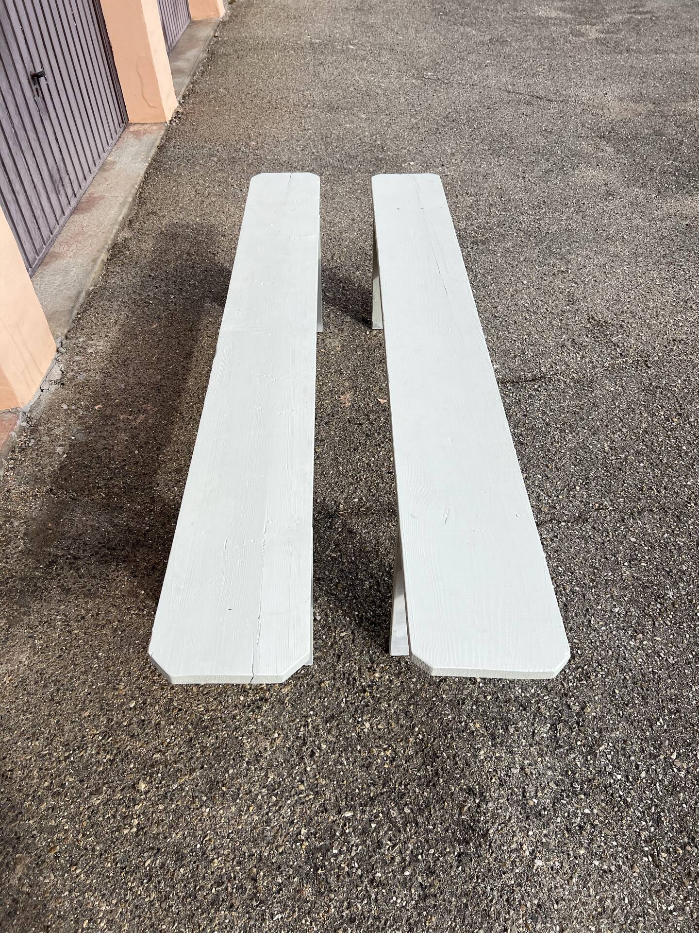 Pair of wooden benches painted white, French artisanal work.