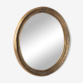 Miroir ovale style Louis XVI patiné doré 80