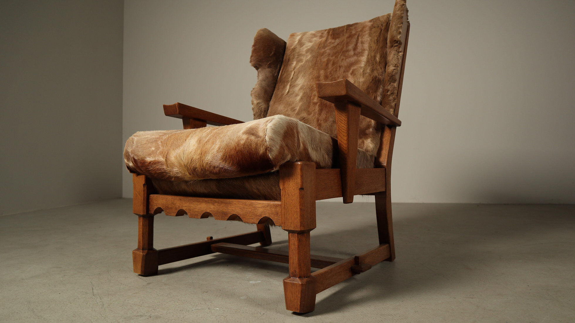 Brutalist oak lounge chair and ottoman in original goat hide, 1960s