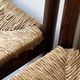 Lot of 4 modernist chairs in solid wood, leather and straw, Italy 1970.