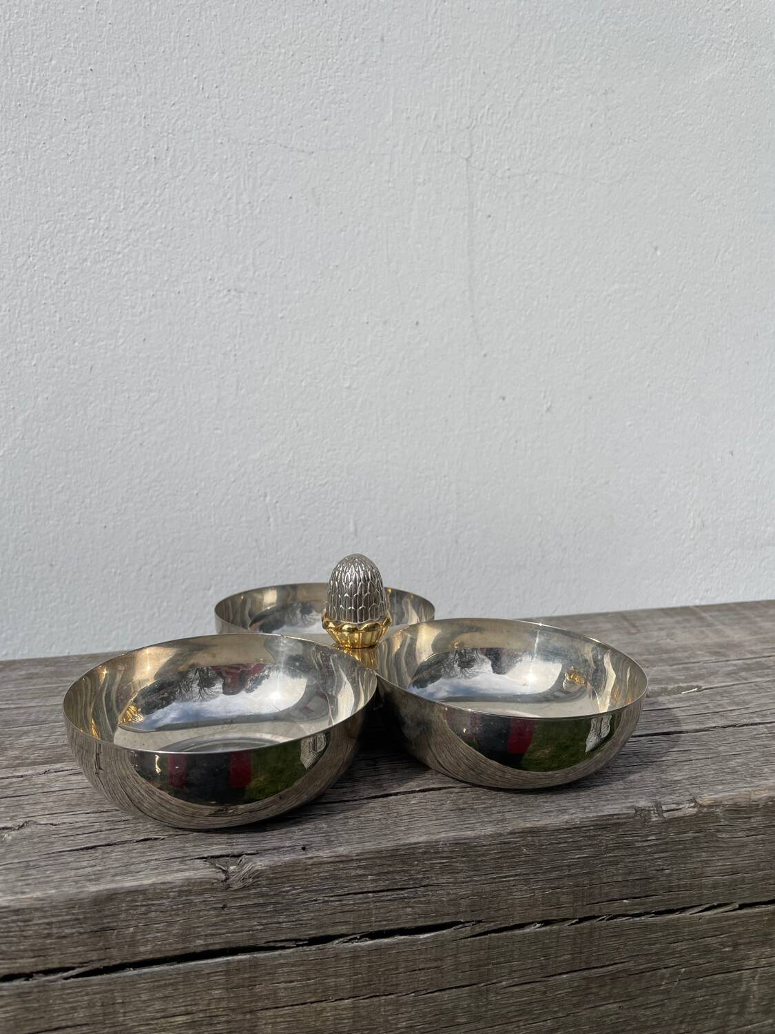 Silver-plated metal dish topped with an acorn